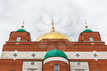 Muslim temple with green and gold domes
