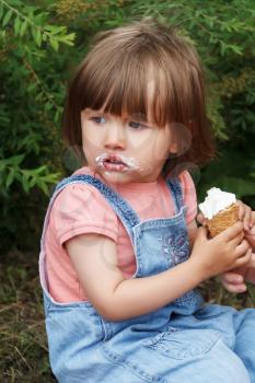 Cute girl are eating icecream in hands