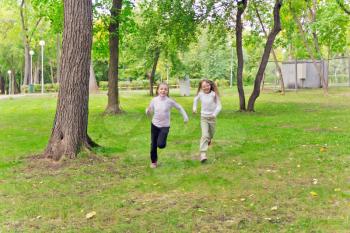 Photo of two running girls in summer