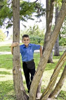 Cute brunette boy eleven years old in summer park