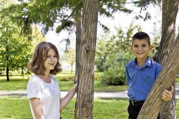 Brother and sister are walking at summer time