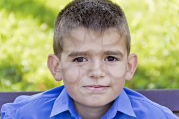 Cute brunette boy eleven years old in summer background