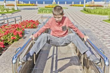 Teenager boy exercise at embankment in summer