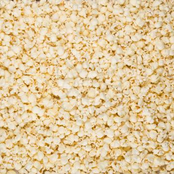 Scattered salted popcorn, texture background. Square format.