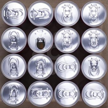 16 drink cans with one opened. Top view, with one opened can