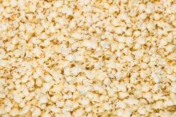 Scattered salted popcorn, texture background. Square format