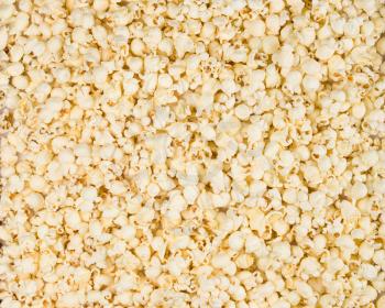Scattered salted popcorn, texture background. Backdrop for a web site, scrapbooking, packaging