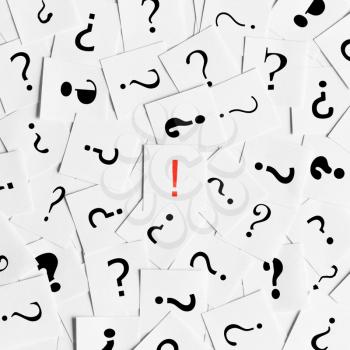 Pile of question mark signs scattered around with one red exclamation symbol in the center. Decision, enquiry or faq concept.