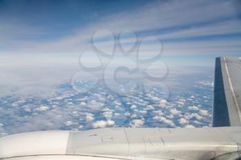 clouds and lands under wing of airplane