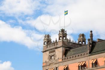 Swedish flag on roof of old house in Stockholm, Sweden 