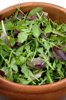 fresh salad mix in wooden bowl closeup