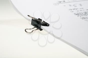 black binders clip on sheets of paper close-up