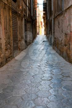 narrow medieval stone street in old Palermo, Sicily