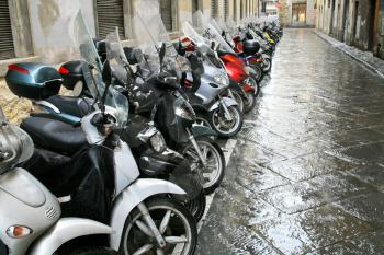 scooters parking in side street in Florence, Italy