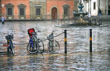 bicycle on Piazza Santissima Annunziata in Florence in rain
