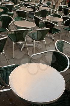 round metal table in empty street cafe