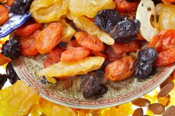 oriental dessert - many dried sweet fruits and nuts on plate close up