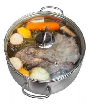 boiling of beef broth with seasoning vegetables in steel pan isolated on white background