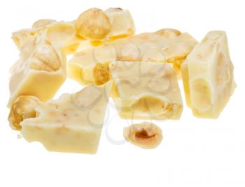 pieces of broken white chocolate with hazelnuts isolated on white background