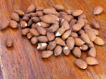 nuts of sweet almonds on wooden table