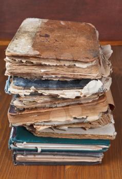stack antique books on wooden bookshelf