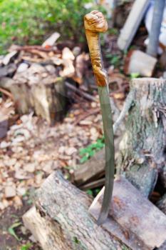 cossack saber and outdoor woodpile in peacetime
