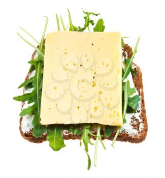 sandwich from rye bread, cheese and fresh arugula isolated on white background