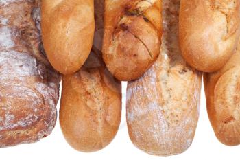 several freshly baked loaves of bread isolated on white background