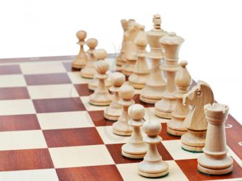 white chess pieces placed on chess board close up