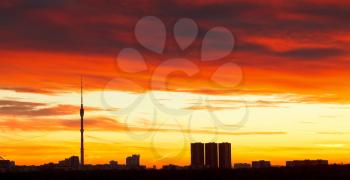 morning skyline with dramatic dark red sunrise sky over urban houses