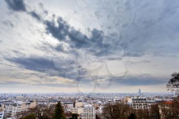 dark grey clouds under big city, Paris, France