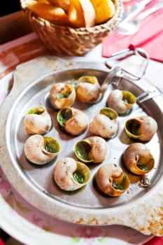 hot plate of escargot shells, with special tongs and fork