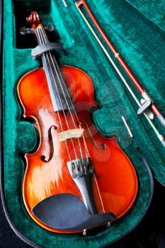 fiddle with bow in green velvet case close up