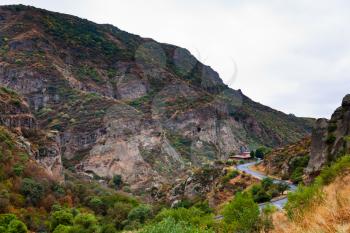 Cliffs and the road in gorge of Azat river in Armenia. Cliffs surrounding Geghard monastery and Azat river gorge are included together with the monastery in the World Heritage Site listing.