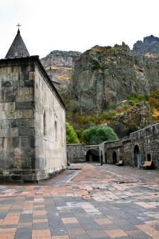 cliffs and courtyard of Geghard monastery in Armenia