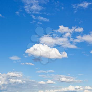 fluffy cumulus cloud in blue sky under stratus clouds