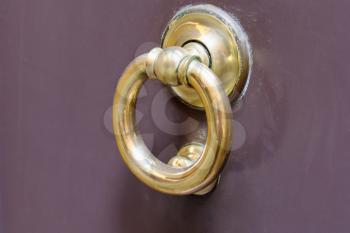 old brass ring door handle on urban door