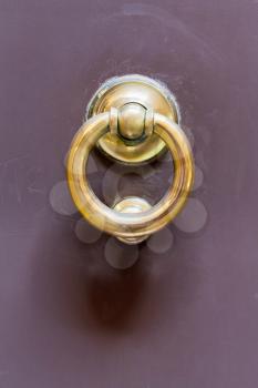 old brass ring door handle on urban door