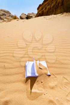 office note book in red sand of Wadi Rum desert in Jordan