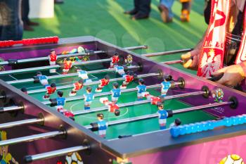 KIEV, UKRAINE - JULY 1: polish fan plays with table football game in fan-zone of Kyiv's Olympic Stadium in Kiev, Ukraine on July 1, 2012. About 2186000 visitors were in fan-zone UEFA EURO 2012 in Kyiv