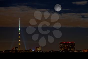 night skyline with full moon and Ostankino tower in Moscow
