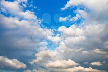 evening cumulus clouds in blue summer sky