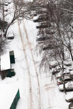 above view of cars covered with snow on parking in Moscow, Russia in winter day