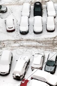 top view of cars covered with snow on parking in Moscow, Russia