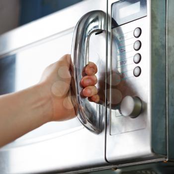 opening of microwave oven door in home kitchen