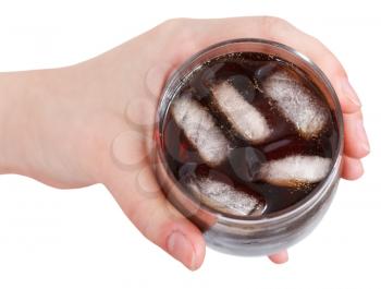 above view of hand holding cola with ice in glass isolated on white background