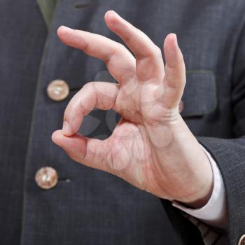 businessman shows Okey sign close up - hand gesture