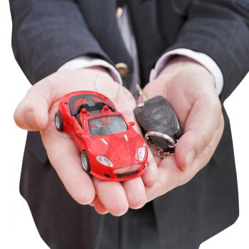 red car and key in seller's hand isolated on white background