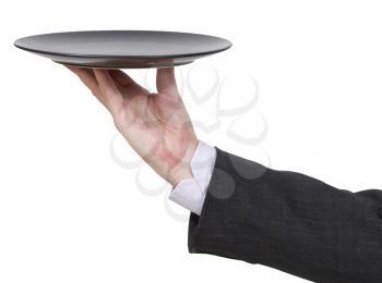 side view of hand with empty flat black plate isolated on white background