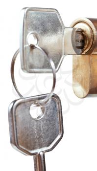 bunch of house keys in cylinder lock close up isolated on white background